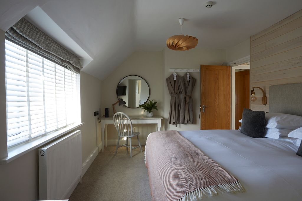 Cosy bedroom with dressing gowns hanging up