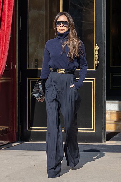 Victoria Beckham wearing a navy polo 