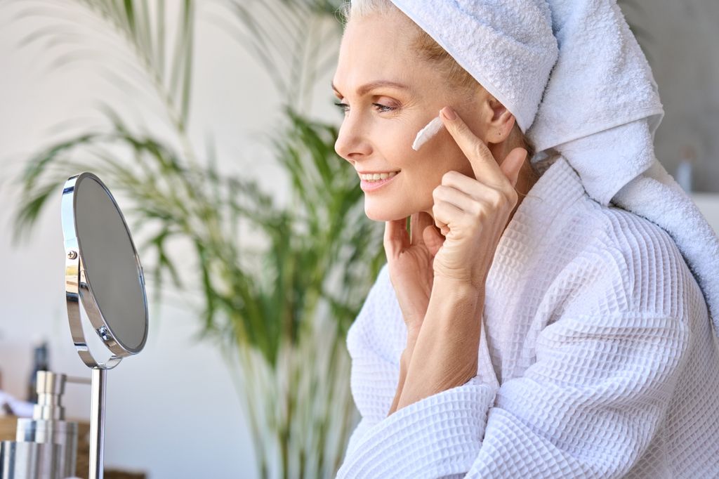 woman applying moisturiser to her face