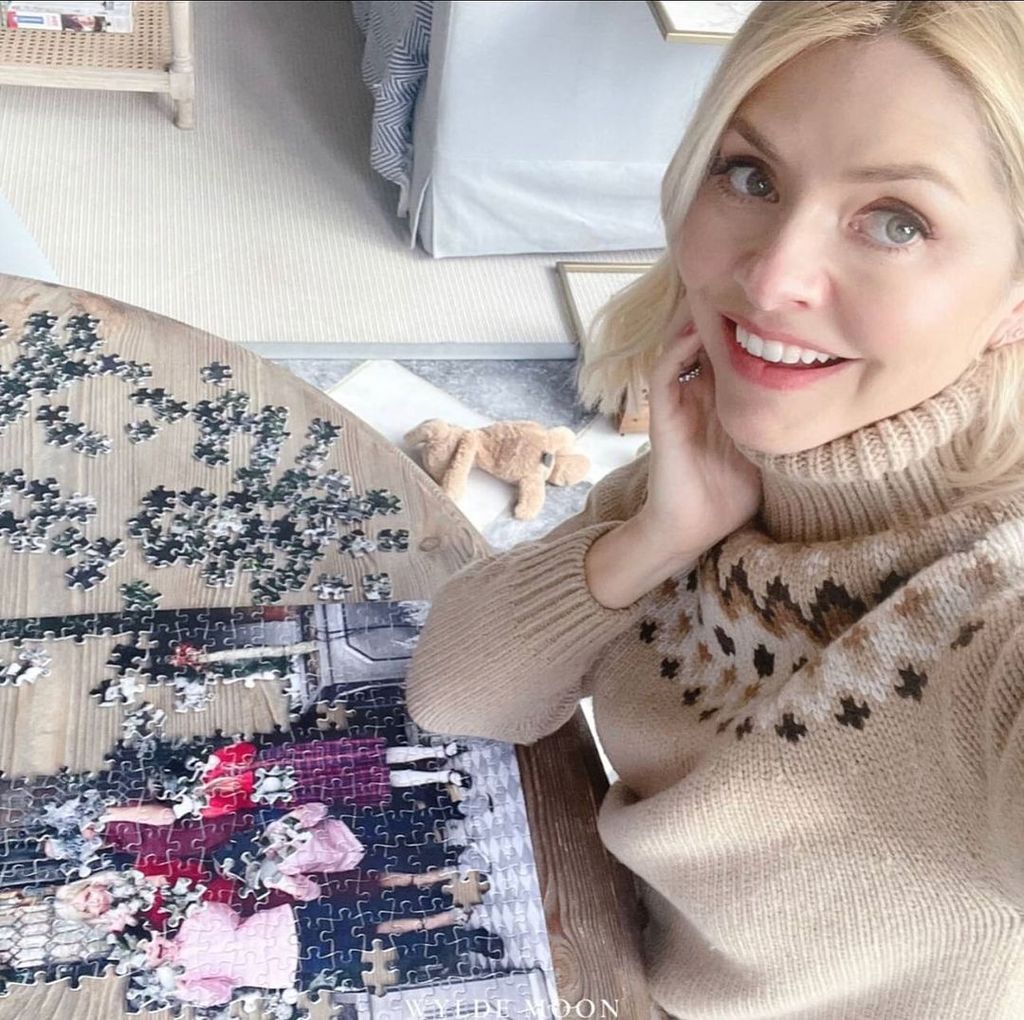 Holly Willoughby posing with a puzzle featuring a family photo