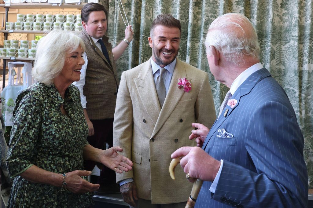 king charles and queen camilla speaking to David Bekcham