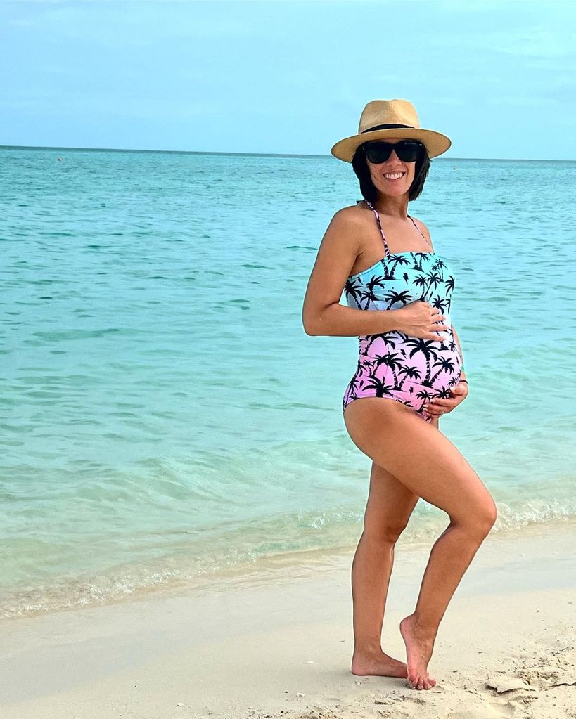 Janette Manrara showing off her baby bump in a swimsuit
