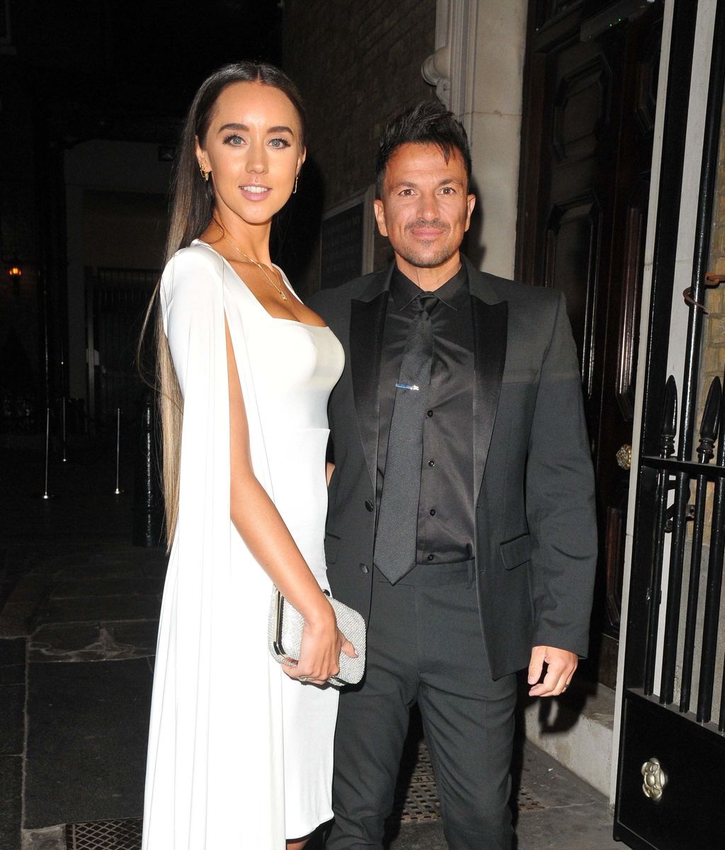 Emily MacDonagh in a white dress next to Peter Andre in a black suit
