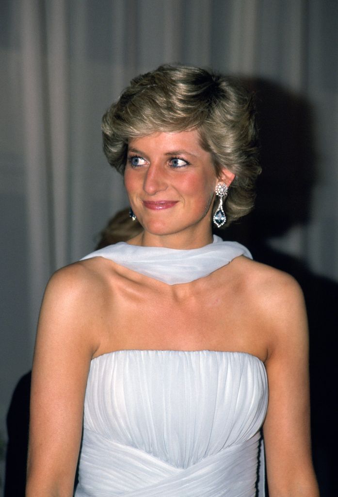 Princess Diana with blue eyeliner and a pale blue dress