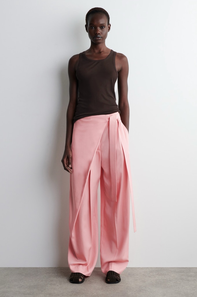 A model wears pink trousers