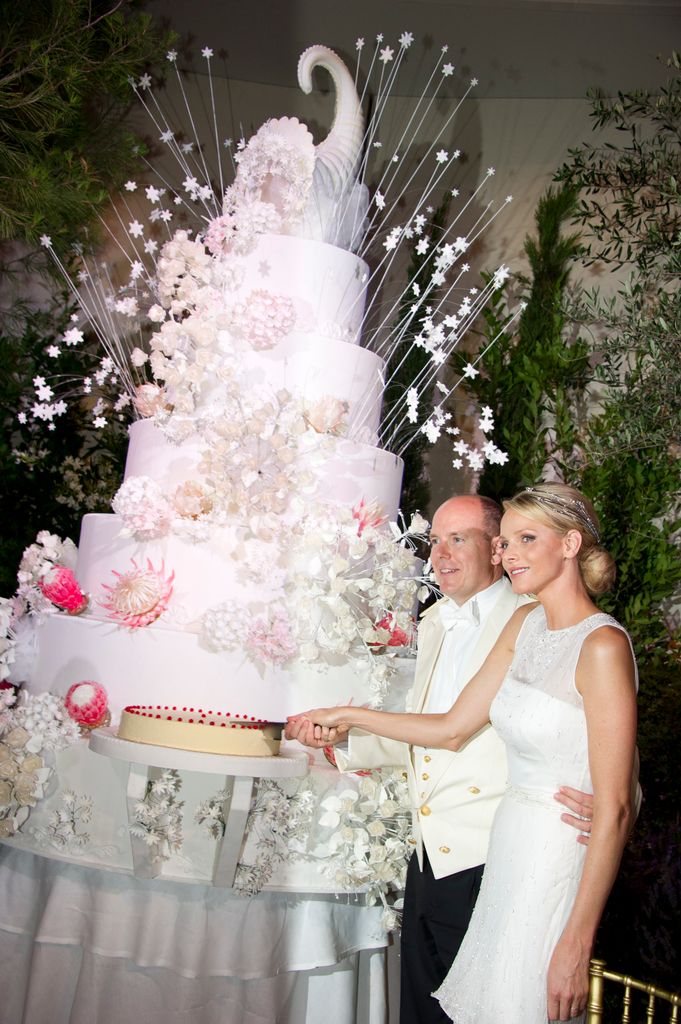 Princess Charlene and albert cutting huge wedding cake