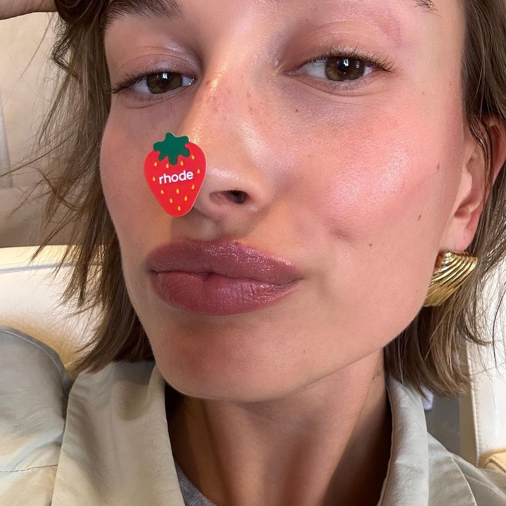 Hailey Bieber shared a selfie with a straeberry sticker on her nose