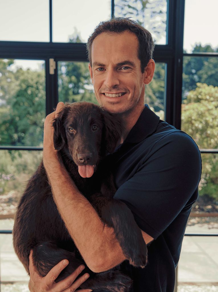 A photo of a man holding a dog 