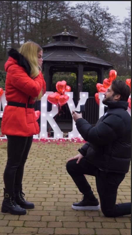 Paul Klein on one knee proposing to Alex Murphy