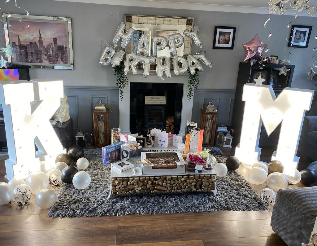 Kym Marsh has a large family lounge complete with powder blue panelling and a rustic fireplace