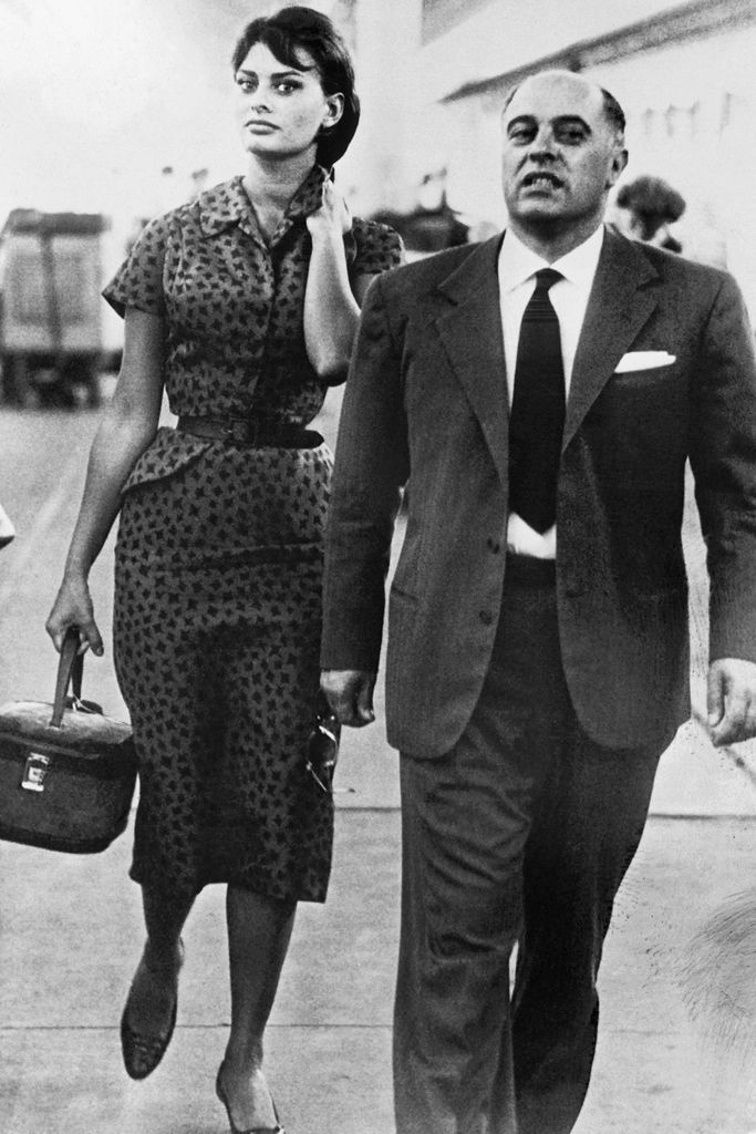 Sophia Loren walking with her husband Carlo in a black and white photo