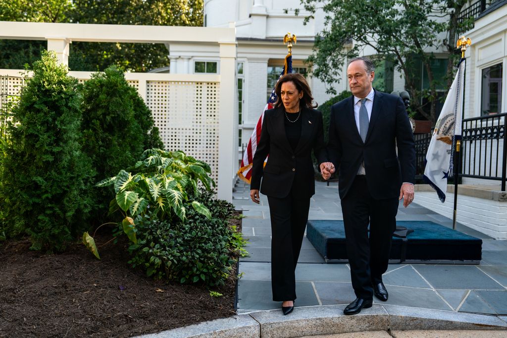 Vice President Kamala Harris and Second Gentleman Doug Emhoff walk over to plant a pomegranate tree at the Vice President's residence at the U.S. Naval Observatory on October 7, 2024 in Washington, DC. The Second couple marked the one-year anniversary of the October 7 attacks in Israel by planting a memorial tree, a tradition done by second families on the grounds of the Vice President 's residence