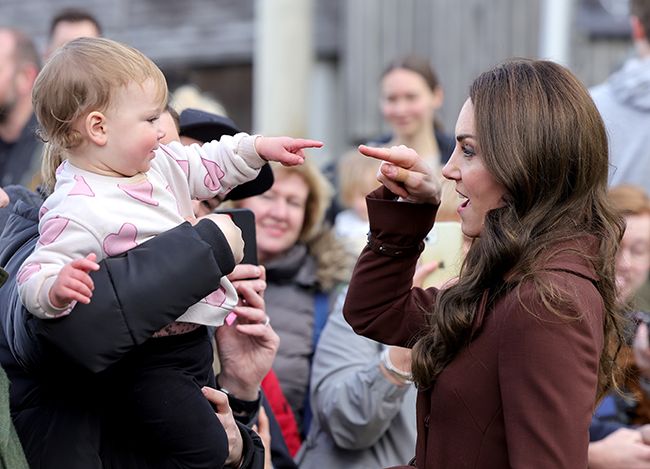 princess kate of wales pointing at sweet baby girl