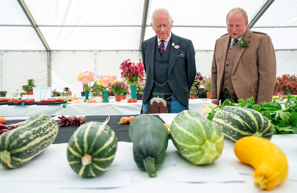 King Charles and chairman Brian Grant view the vegetable competition 