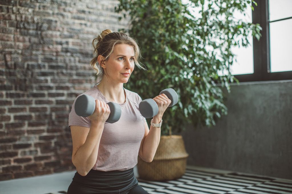 Women working out at home in a light tshirt