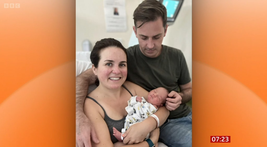 Nina Warhurst photo cradling third newborn baby