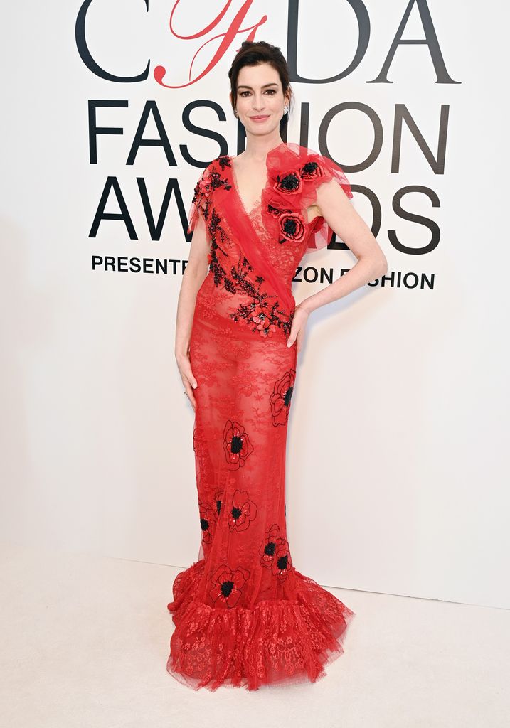 Anne Hathaway wearing a red gown by Rodarte at the CFDAs 