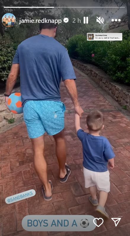Jamie Redknapp holds the hand of his youngest son