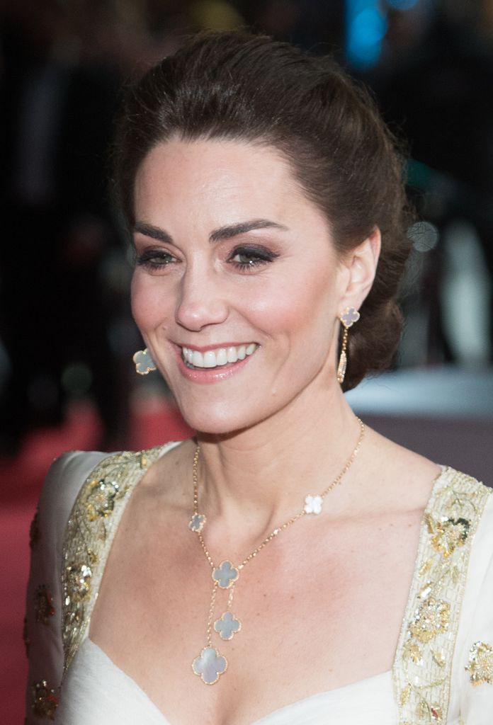 Kate in white and gold dress with van cleef jewellery