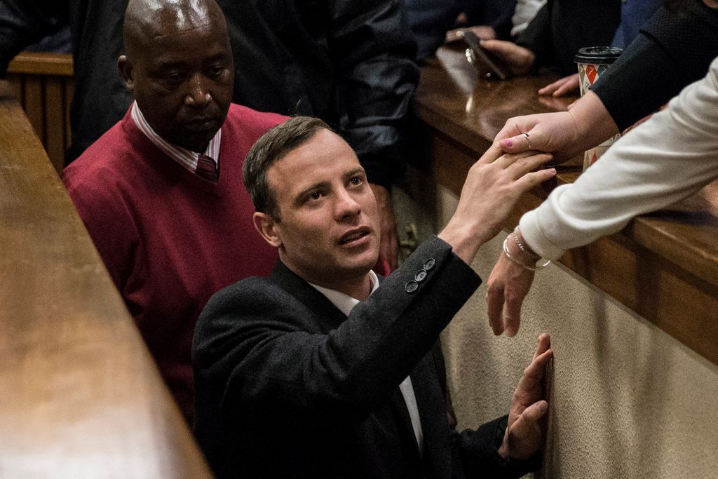 PRETORIA, SOUTH AFRICA - JULY 6:  Olympic athlete Oscar Pistorius holds the hand of a relative after sentencing at the High Court on July 6, 2016 at the High Court in Pretoria, South Africa. Pistorius was sentenced to six years in prison for the murder of girlfriend Reeva Steenkamp at their home in 2013.  (Photo by Marco Longari - Pool/Getty Images)