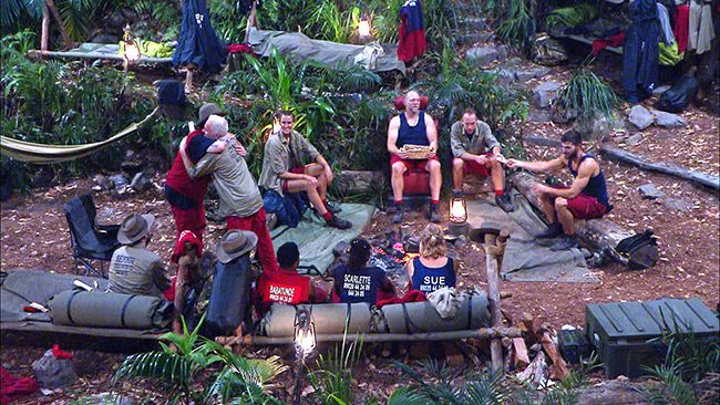 im a celeb camp mates sit around reading letters from home
