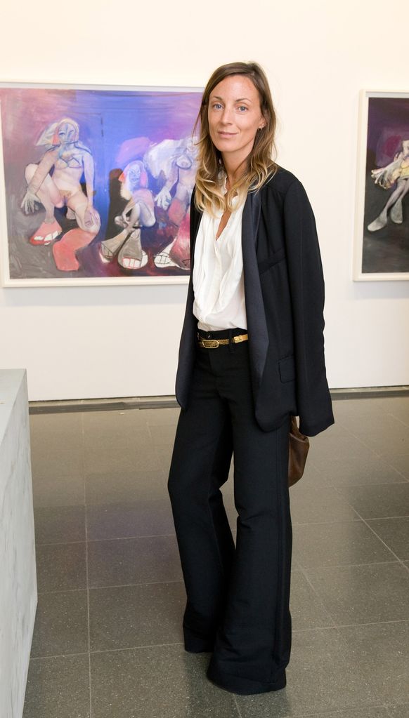 Phoebe Philo wearing a white shirt, black blazer and matching suit trousers 