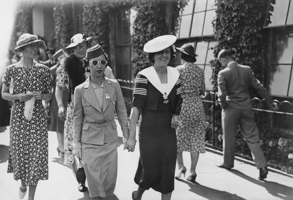 Two women holding hands and wearing army (left) and navy style outfits, Wimbledon, London, 21st June 1938. (Photo by J. A. Hampton/Hudson/Topical Press Agency/Hulton Archive/Getty Images)