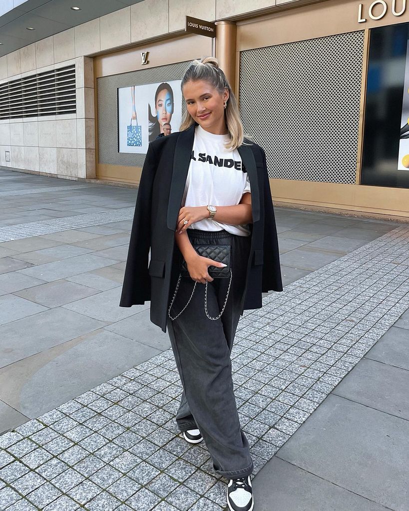 Molly Mae poses on her instagram in a t-shirt, blazer and trainer look