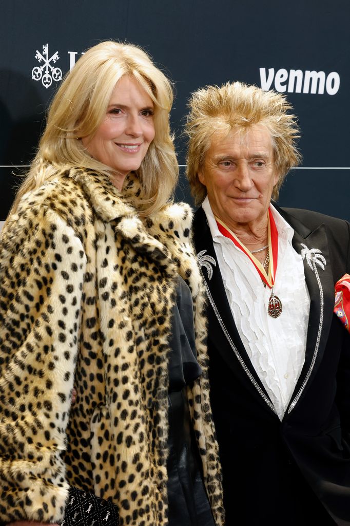 Penny Lancaster in a leopard-print coat alongside Rod Stewart