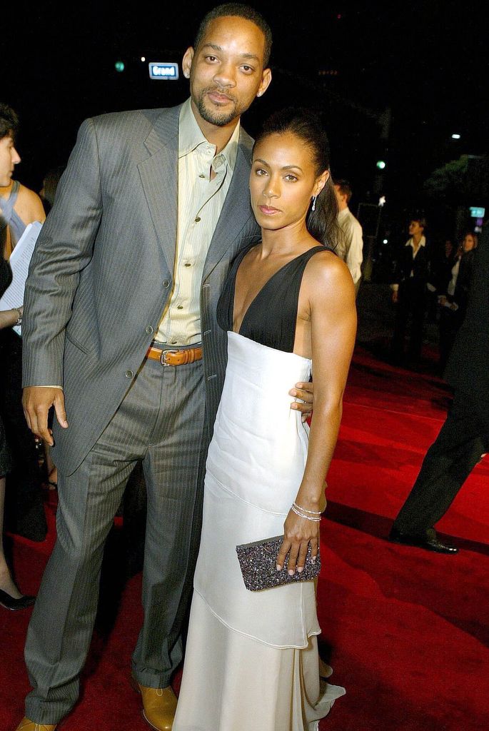 Will Smith in a suit and Jada Pinkett Smith in a black and white dress