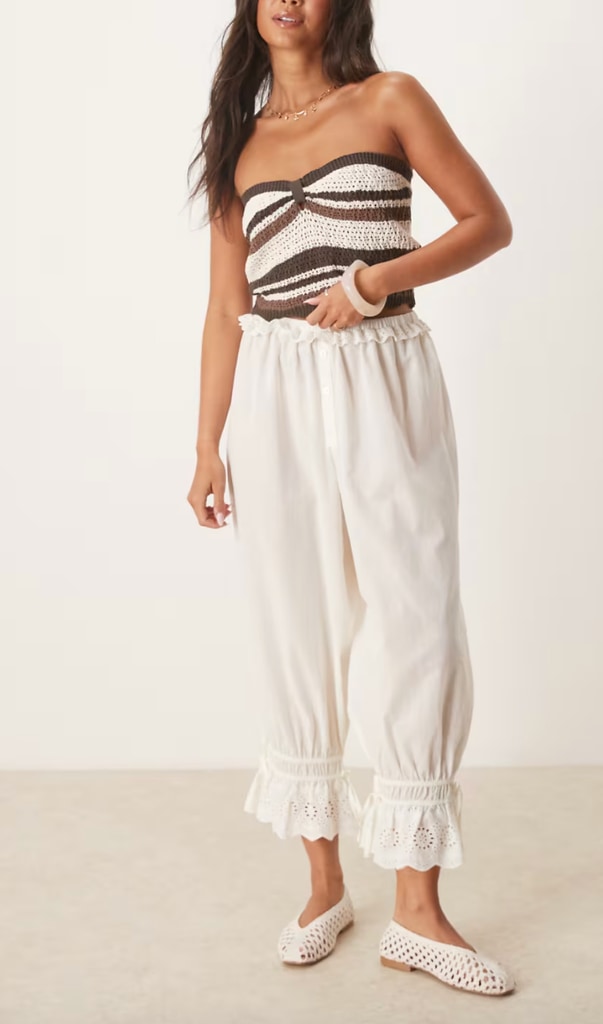 A model wears a stripe crop and white trousers