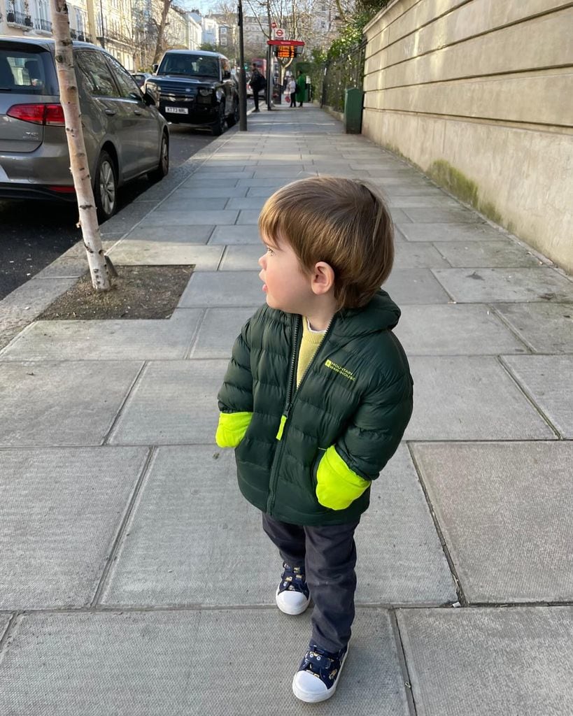 Princess Eugenie's son Ernest wearing puffer jacket walking on street