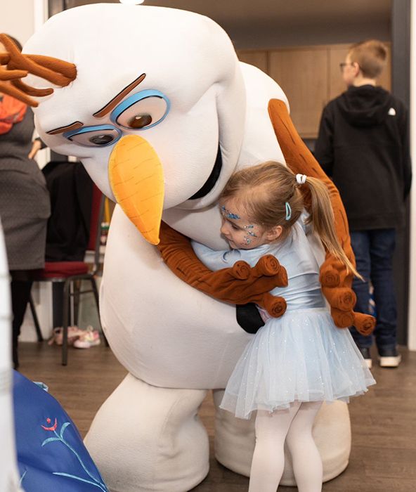 Ella hugs Olaf at birthday tea party