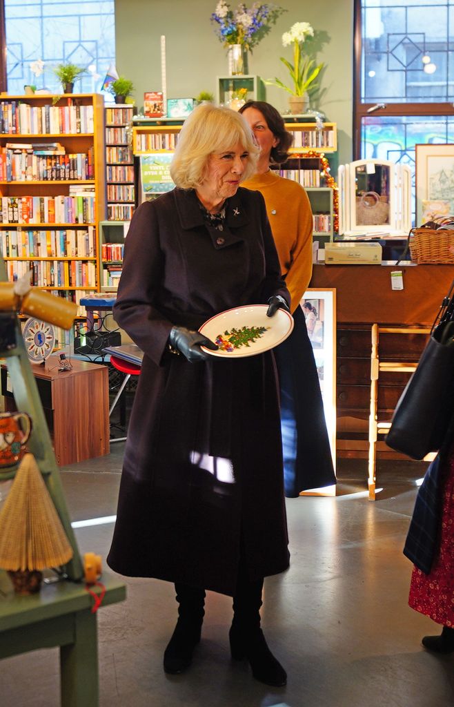 Queen Camilla holding a plate