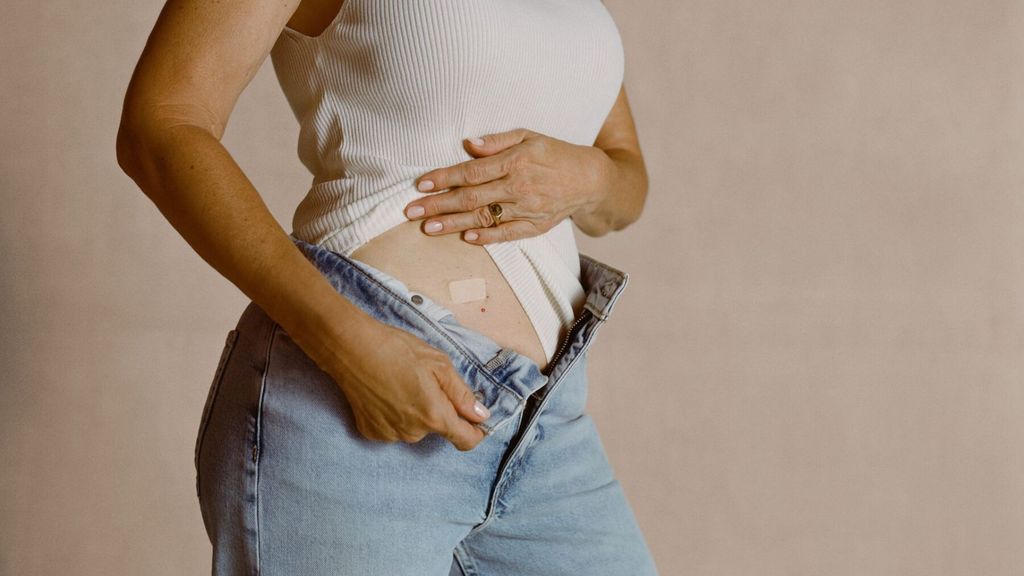 woman showing patch on stomach