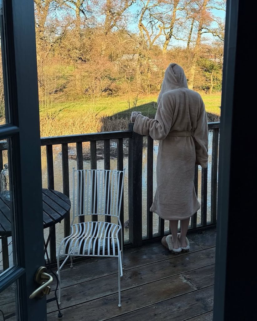 Meghann Fahy standing on a decking overlooking a lake