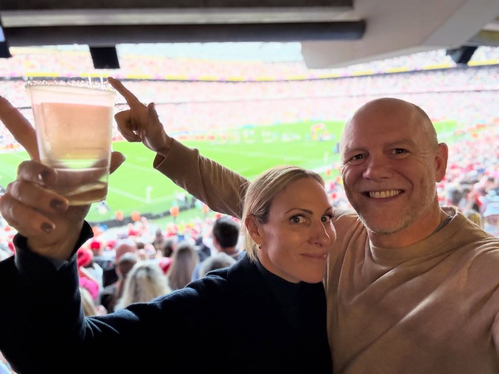 Zara and Mike arms up selfie in stadium