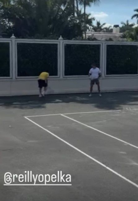 Brooklyn Beckham playing tennis with Nicola Peltz's brother