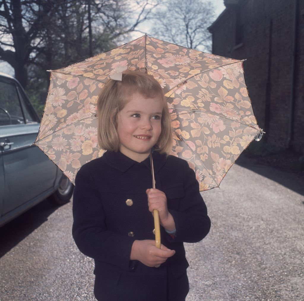 A young Lady Helen Taylor holding an umbrella