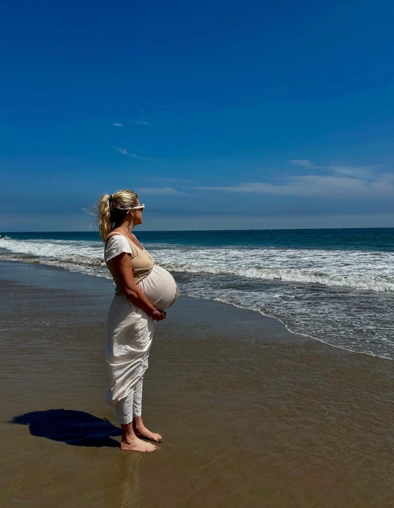 Photo shared by Eric Christian Olsen's wife Sarah Wright of the her at the beach, 41 weeks pregnant, holding her baby bump