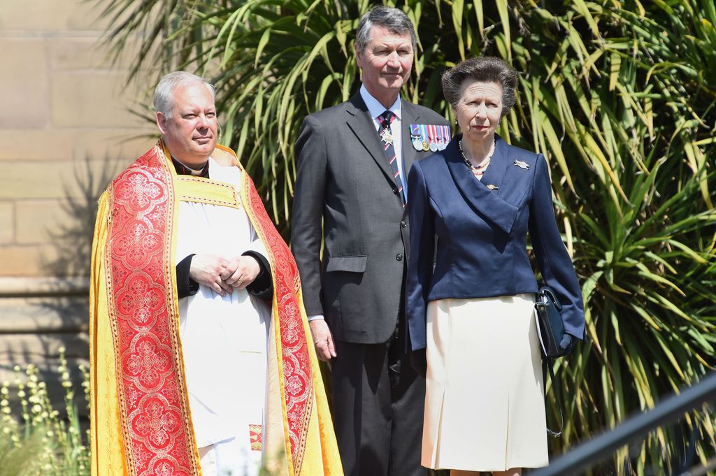 Princess Anne and Sir Timothy Laurence with rector of a church