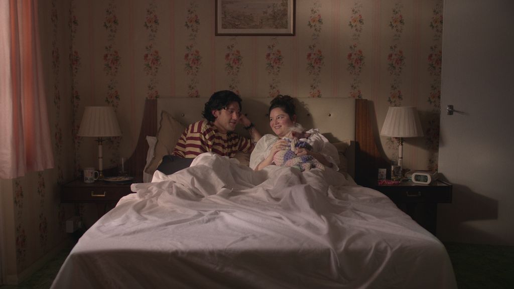 man and woman sitting in bed