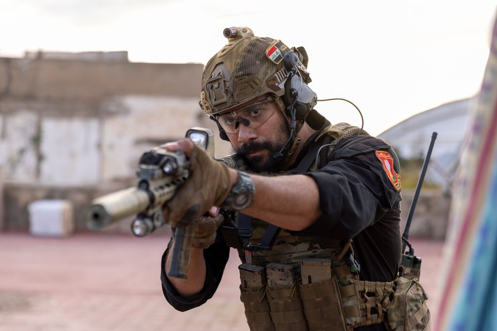 man in military holding gun