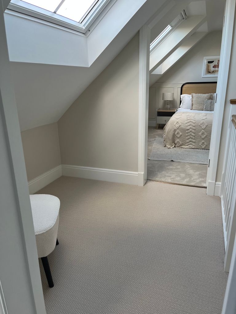 neutral themed attic bedroom from hallway