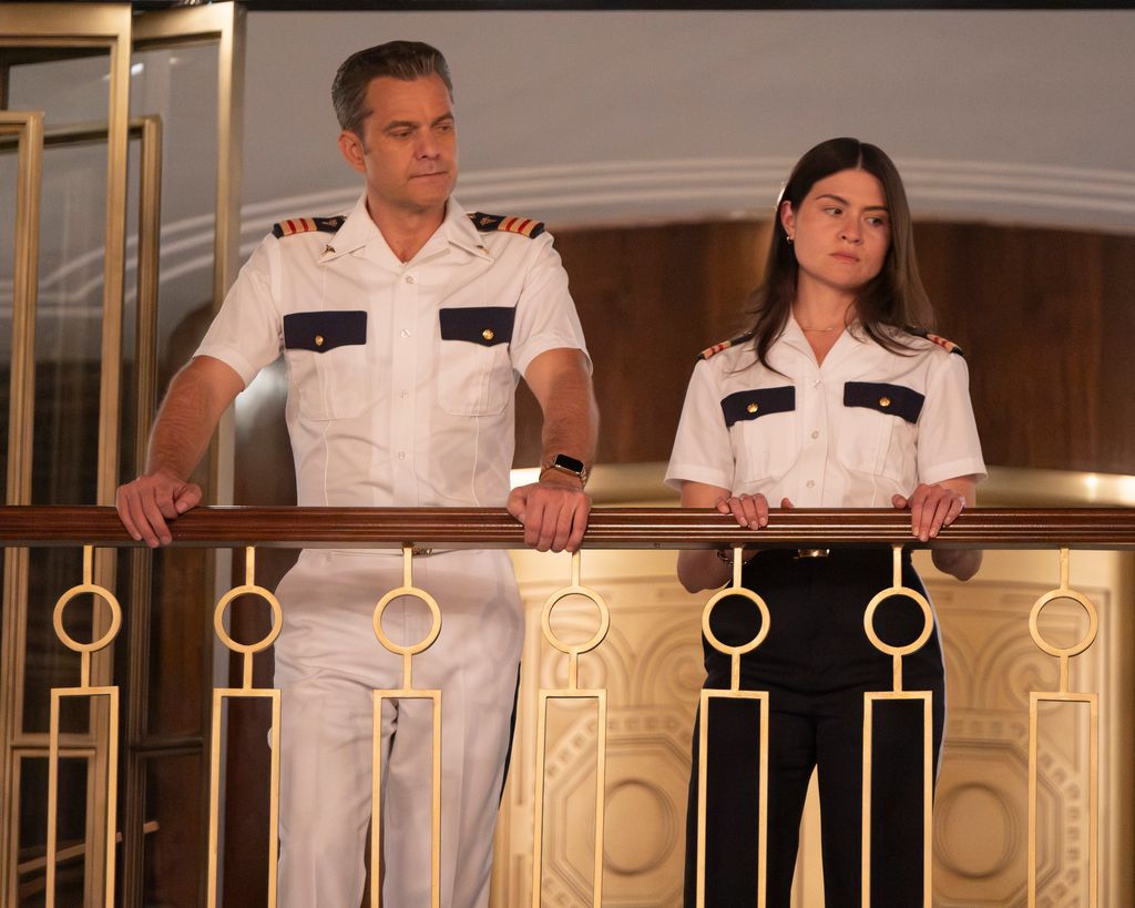 man and woman standing on balcony