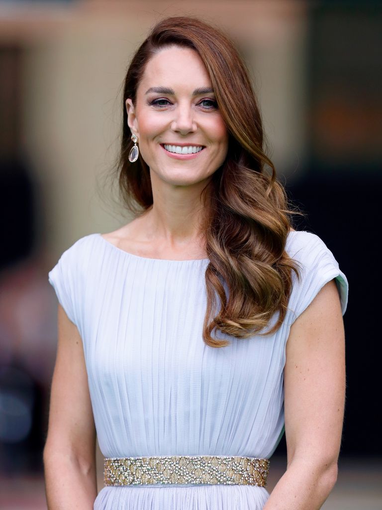 Catherine smiling with hair on one shoulder