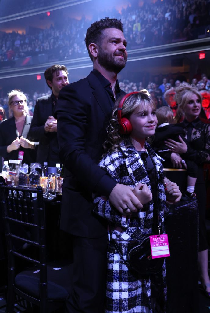 Jack Osbourne, his daughter Andy standing in a crowd