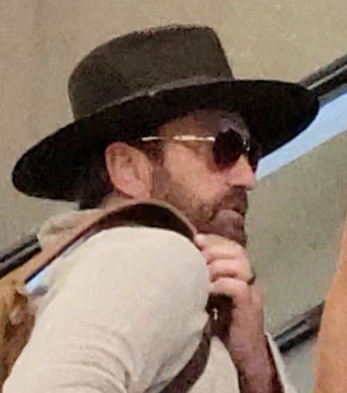 Gerard Butler turned heads at LAX with girlfriend Morgan Brown wearing a wedding band