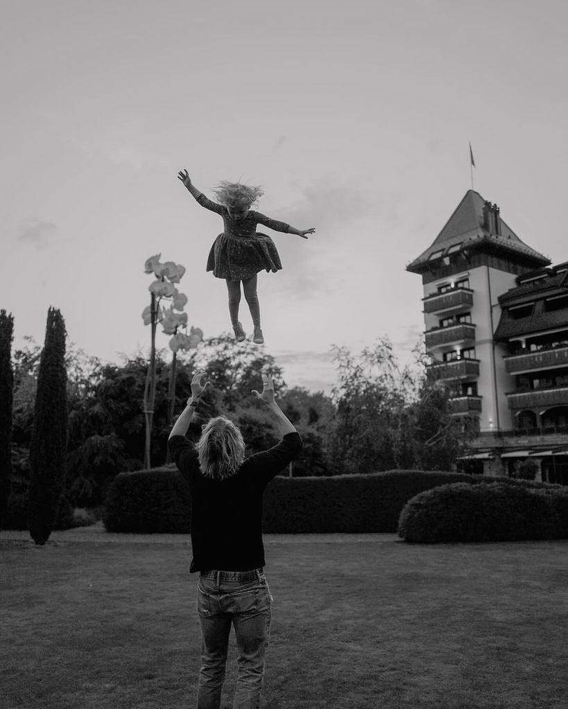 Eric Christian Olsen throws his youngest daughter Winter in the air