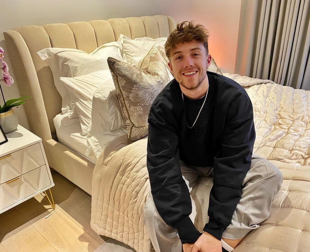 Roman Kemp sitting on his bed in his bedroom